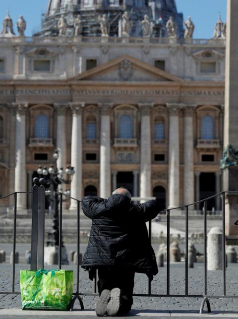A man prays in front of an empty St. Peter's Square in Rome March 25. (CNS/Reuters/Guglielmo Mangiapane) A man prays in front of an empty St. Peter's Square in Rome March 25. (CNS/Reuters/Guglielmo Mangiapane)