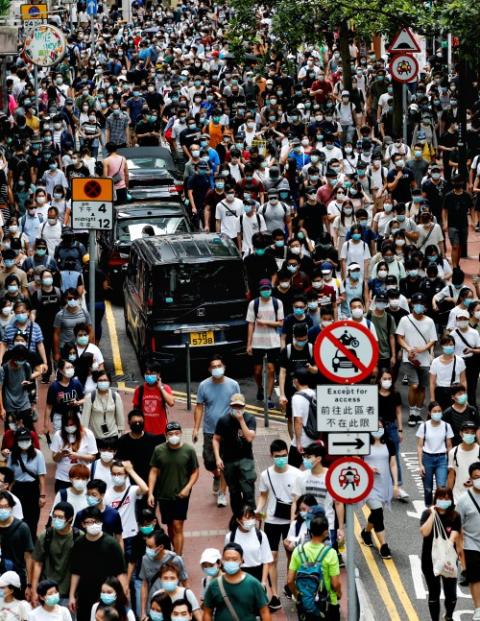 Demonstrators march during a protest against the national security law in Hong Kong July 1. (CNS/Reuters/Tyrone Siu) Demonstrators march during a protest against the national security law in Hong Kong July 1. (CNS/Reuters/Tyrone Siu)