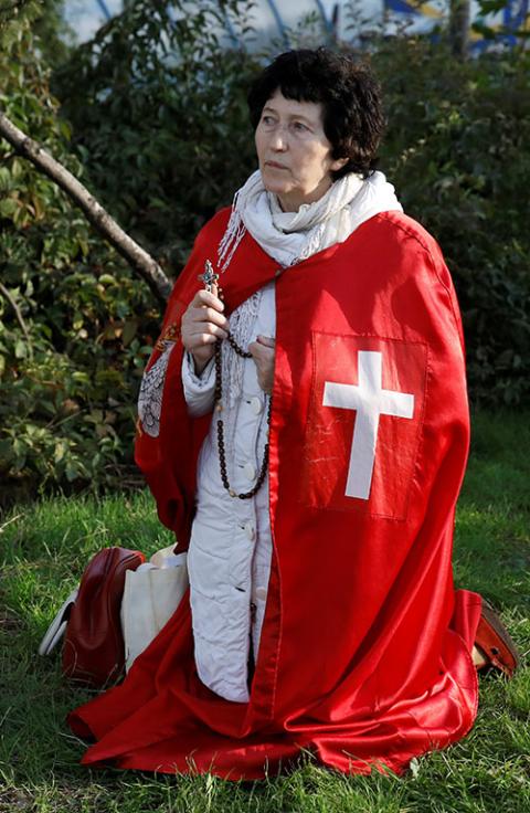 A demonstrator prays holding a rosary during an Oct. 24, 2020, rally in Warsaw, Poland, against measures imposed by the Polish government to stem the spread of the coronavirus. (CNS/Reuters/Kacper Pempel) A demonstrator prays holding a rosary during an Oct. 24, 2020, rally in Warsaw, Poland, against measures imposed by the Polish government to stem the spread of the coronavirus. (CNS/Reuters/Kacper Pempel)