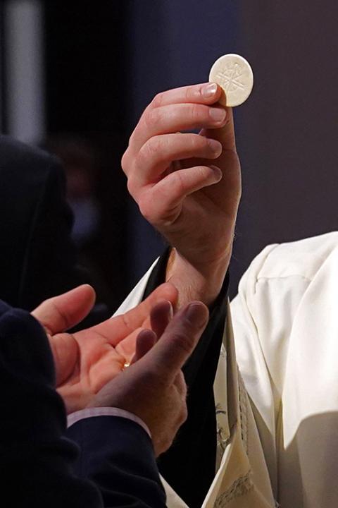 A priest gives the Eucharist to a communicant during a Mass at St. Agnes Cathedral in Rockville Centre, New York, in 2020. (CNS/Gregory A. Shemitz) A priest gives the Eucharist to a communicant during a Mass at St. Agnes Cathedral in Rockville Centre, New York, in 2020. (CNS/Gregory A. Shemitz)