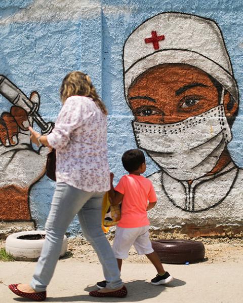 A woman and child walk past a painting on a wall in Rio de Janeiro March 12 during the COVID-19 pandemic. (CNS/Reuters/Pilar Olivares) A woman and child walk past a painting on a wall in Rio de Janeiro March 12 during the COVID-19 pandemic. (CNS/Reuters/Pilar Olivares)
