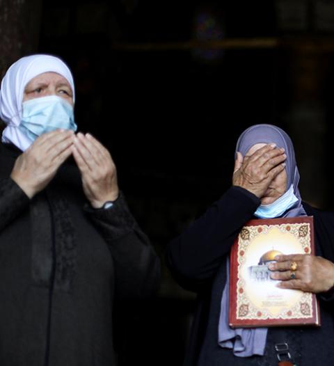 Palestinian women pray near the Dome of the Rock in Jerusalem's Old City April 16, on the first Friday of the holy month of Ramadan. (CNS/Reuters/Ammar Awad)