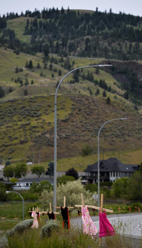 Children's dresses hang on crosses near the grounds of the former Kamloops Indian Residential School June 6. (CNS/Reuters/Jennifer Gauthier) Children's dresses hang on crosses near the grounds of the former Kamloops Indian Residential School June 6. (CNS/Reuters/Jennifer Gauthier)