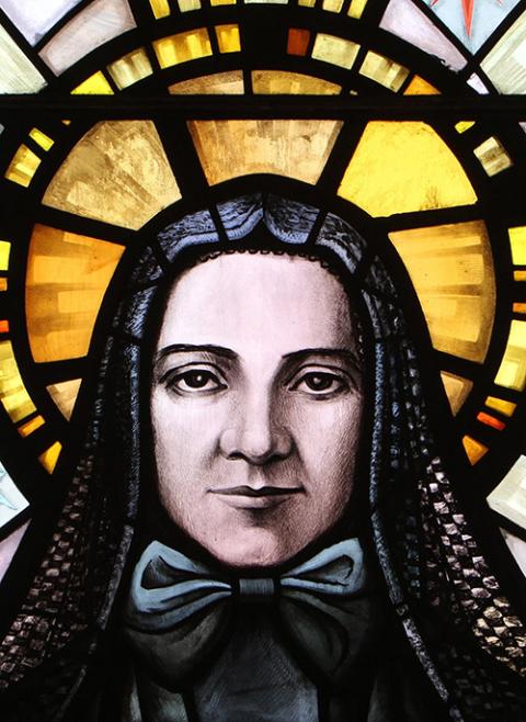 St. Frances Xavier Cabrini, patron of immigrants, is depicted in a stained-glass window at the saint's shrine chapel in New York City. Mother Cabrini and her sisters worked with immigrants, schoolchildren and the poor. (CNS/Gregory A. Shemitz)