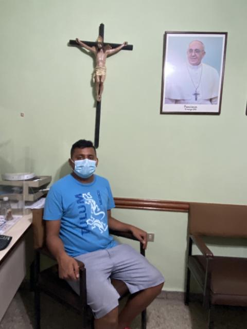 Jose Andres Martinez sits for an interview Aug. 17 at Our Lady of Mount Carmel Church in San Salvador, El Salvador. Martinez, a former sacristan, recently returned to his native El Salvador after six attempts to cross the U.S.-Mexico border. (CNS)