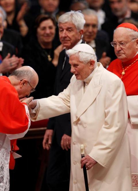 Pope Benedict shakes hands with cardinals. 