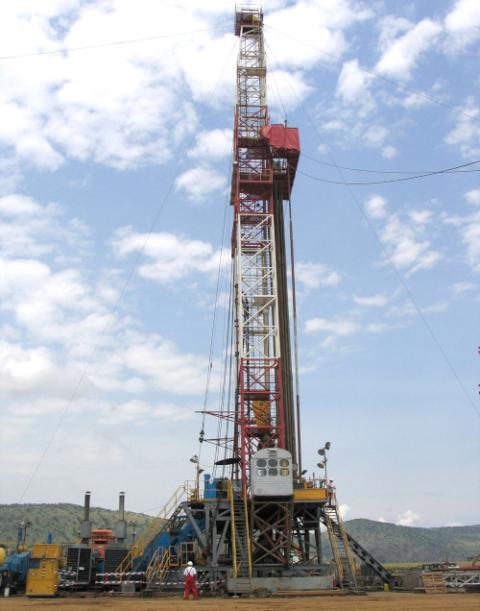 An oil rig is pictured preparing to drill in western Uganda, near the shores of Lake Albert. (CNS/Reuters/Tim Cocks)