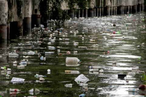 Plastic bottles float on the heavily polluted San Juan River, a tributary of Pasig River in Mandaluyong City, Philippines, June 21, 2021. (CNS/Reuters/Eloisa Lopez)