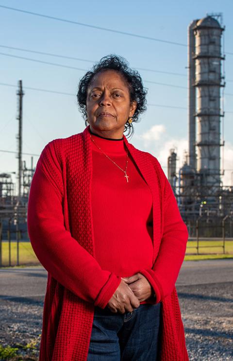 Sharon Lavigne stands in front of a chemical plant near her home in St. James Civil Parish, Louisiana, March 13. (CNS/Courtesy University of Notre Dame/Barbara Johnston)