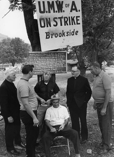 Msgr. George Higgins, second from right, lends support to striking mine workers in Kentucky's Harlan County in this 1974 file photo. (CNS/file photo)