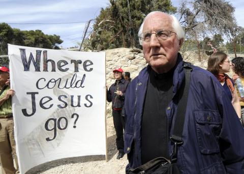 Retired Auxiliary Bishop Thomas Gumbleton of Detroit joins local Palestinians and international visitors for a Palm Sunday procession from Lazarus' tomb in Bethany to the Bethany Gate at the Israeli separation wall March 16, 2008, in the West Bank. (CNS)