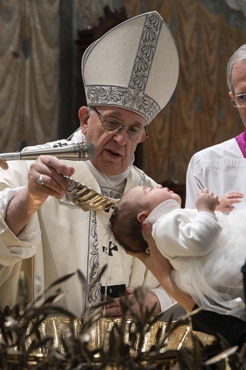 Pope Francis baptizes one of 27 babies during a Mass on the feast of the Baptism of the Lord in the Sistine Chapel Jan. 13, 2019, at the Vatican. (CNS/Vatican Media)
