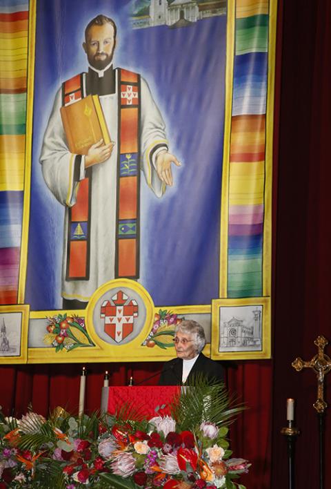 Sr. Marita Rother gives a reading during Mass during the beatification ceremony for her brother, Blessed Stanley Rother Sept. 23, 2017, in Oklahoma City. At rear is a large banner with the image of Blessed Stanley Rother. (AP photo/Sue Ogrocki, file)