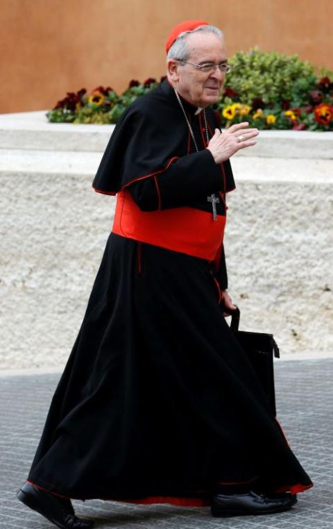 Cardinal Rigali waves as he walks at Vatican.