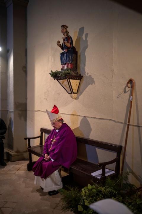 Local bishop Francesc Conesa sits next to the virgin Our Lady of the Torrents as he leads a mass in l'Espunyola, north of Barcelona, Spain, Sunday, March 26, 2023. (AP Photo/Emilio Morenatti)