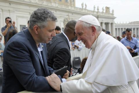 Pope Francis greets Evgeny Afineevsky, a documentary filmmaker, at his general audience at the Vatican in this Aug. 28, 2019, photo. (CNS/Vatican Media via Evgeny Afineevsky)