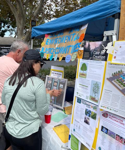 Parishioners stop at the social and environmental justice committee's activity booth at the St. Anthony Parish Fall Festival Sept. 17, 2022, in Sacramento. (Courtesy of Kim-Son Ziegler)