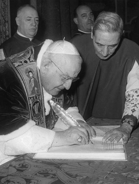Pope John XXIII signs the bull convoking the Second Vatican Council Dec. 25, 1961. (CNS)