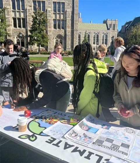 The Climate Justice at Boston College club presents information about fossil fuel divestment during Harvest Fest in a photo posted to the Climate Justice at Boston College instagram account on Oct. 21, 2022. (Courtesy of CJBC via @bcclimatejustice Instagram account)