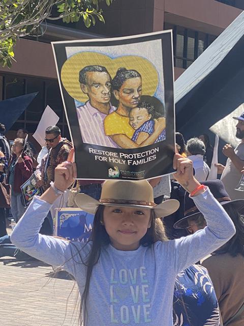 Natalie Gonzalez, 7, holds a sign May 7 in front of the federal building that houses U.S. Immigration and Customs Enforcement in downtown San Diego as members of Our Lady of Guadalupe parish pray for compassionate asylum laws. (NCR photo/Rhina Guidos)