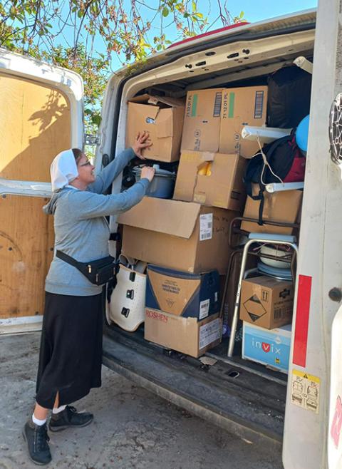 Sr. Lydia Timkova begins to unload items of a shipment she and Katarína Pajerská, who coordinates the Slovak mission of Caritas in Ukraine shepherded across Ukraine during a recent humanitarian mission. (Courtesy of Lydia Timkova)