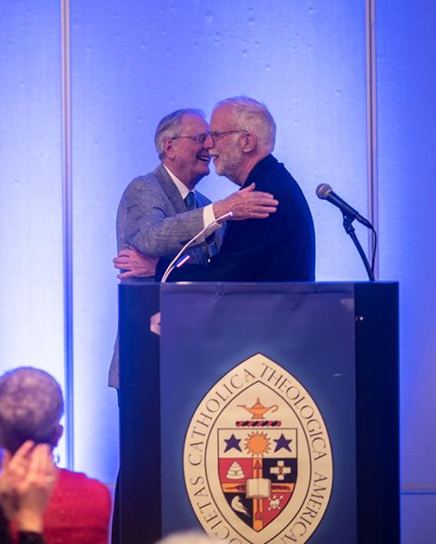 Jesuit Fr. Roger Haight, left, and Fr. Francis X. Clooney, president of the Catholic Theological Society of America, are pictured June 10 in Milwaukee. Clooney presented Haight with the annual John Courtney Murray Award for Distinguished Theological Achievement. (Paul Schutz/Catholic Theological Society of America)