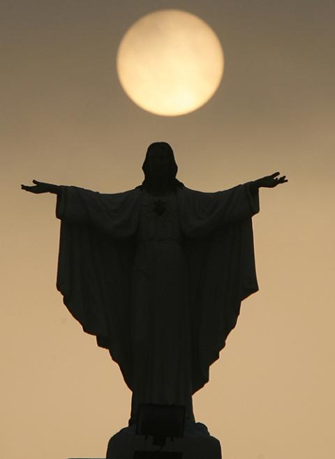 A statue of Christ is seen in silhouette during sunrise at Resurrection of Our Lord Church in Paranaque, outside Manila, Philippines, Feb. 23, 2010. (CNS/Reuters/Erik de Castro)