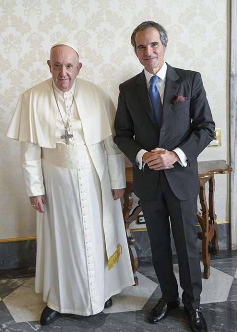 Pope Francis and Rafael Mariano Grossi, director general of the International Atomic Energy Agency, pose for photos Jan. 12 in the library of the Apostolic Palace. Grossi said they discussed the threat of a disaster from bombings of a nuclear power plant in Ukraine. (CNS photo/Vatican Media)