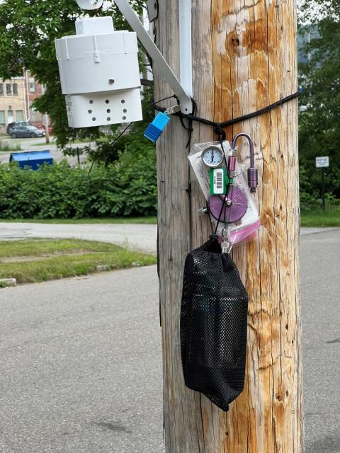 A passive air sampling device, blue near top, and other monitoring equipment on a utility pole in East Palestine, Ohio, July 17, 2023. (RNS photo/Kathryn Post)