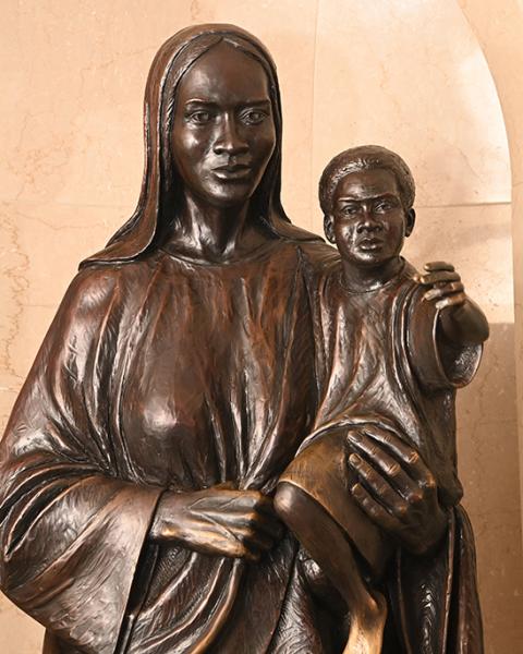 A bronze sculpture of Mary holding the Christ Child is seen Sept. 17, 2022, at the Our Mother of Africa Chapel at the Basilica of the National Shrine of the Immaculate Conception in Washington. Created by artist Ed Dwight, both figures have African American features. (CNS/Patrick Ryan for the National Black Catholic Congress via Catholic Standard)