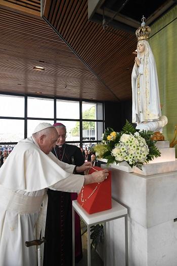 Pope Francis leaves a rosary before a statue of Mary in the Chapel of the Apparitions at the Shrine of Our Lady of Fátima in Fátima, Portugal, Aug. 5, 2023. 