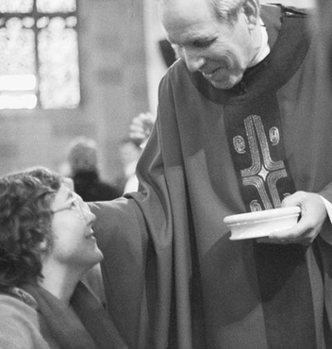Bishop Matthew Clark gives Communion at a diocesan Mass for gays, lesbians, their families and friends in 1997 at Sacred Heart Cathedral in Rochester, New York. (CNS/Catholic Courier/Matthew H. Scott)