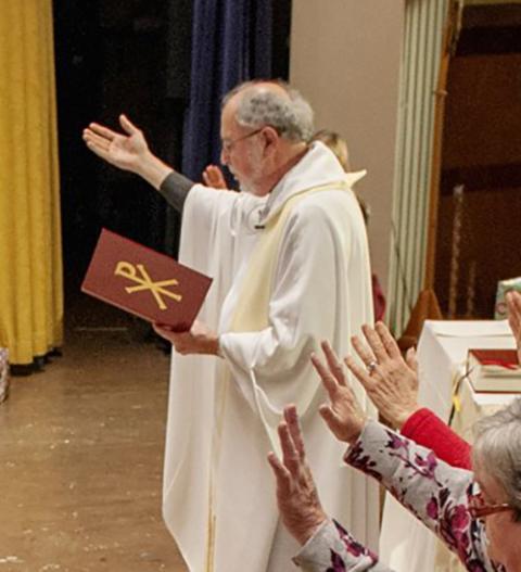 Fr. Bob Werth leads a blessing in 2013. (CNS/Catholic Courier/Mike Crupi) 