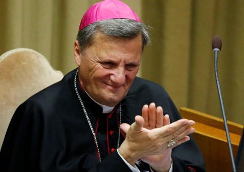 Cardinal Mario Grech claps.