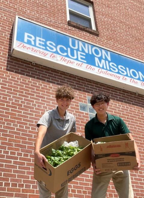 Mason Mathews and Jin Kang, students at Bishop Walsh School in Cumberland, Md., display lettuce Aug. 8, 2023, to be delivered to Union Rescue Mission in Cumberland that was grown and harvested in the school's aquaponics lab. (OSV News photo/courtesy Bishop Walsh School)
