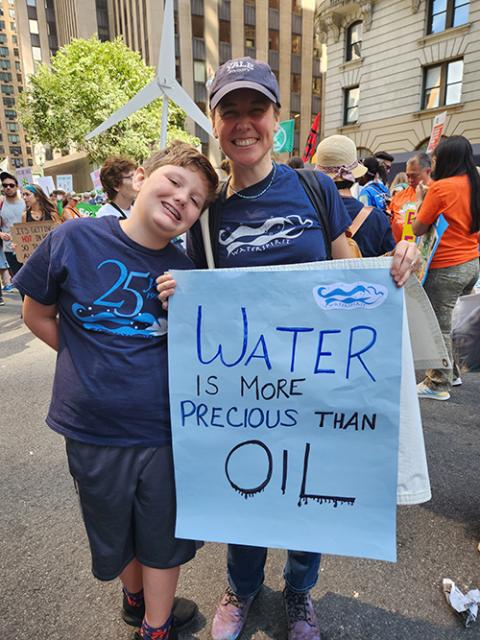 Blair Nelsen, lay representative at the U.N. for the Congregation of the Sisters of St. Joseph of Peace and the executive director of ecospiritual nonprofit Waterspirit, at the Sept 17 climate march joined by her son, Noah Prata Nelsen. (GSR photo/Chris Herlinger)