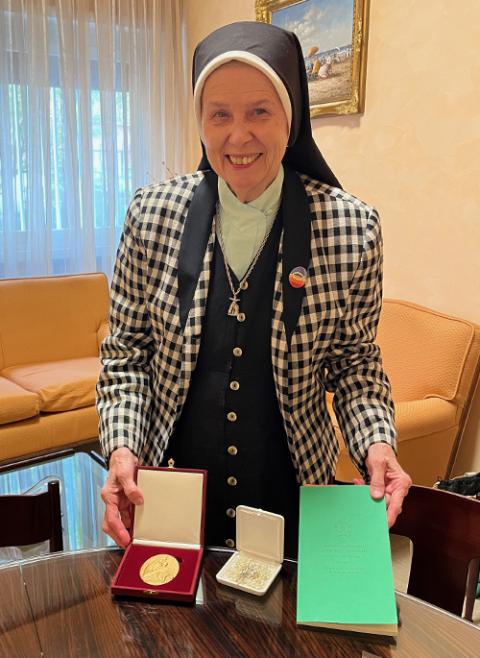 Loretto Sr. Jeannine Gramick, posing with items given to her by Pope Francis, during their meeting together on Oct. 17 (NCR photo/Joshua J. McElwee)