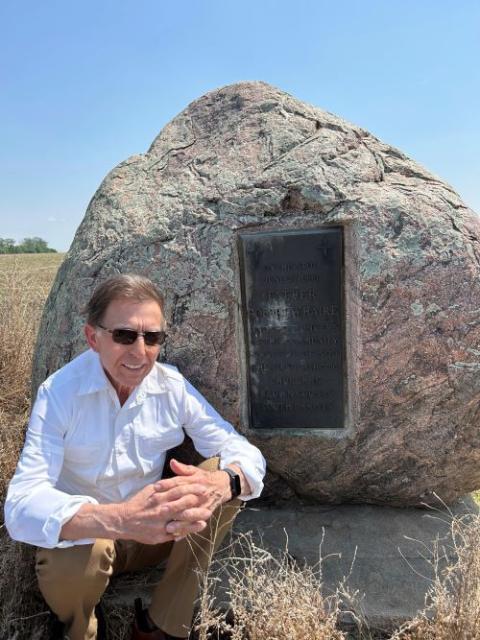 South Dakota businessman Tom Heinz poses in front of a monument marking the first Catholic church in Brown County, South Dakota.