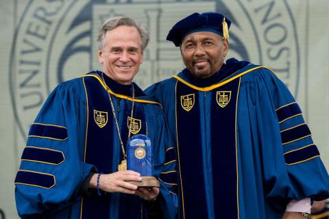 Holy Cross Fr. John Jenkins, president of the University of Notre Dame in Indiana, poses for a photo with Laetare Medal awardee Aaron Neville at the university's 2015 commencement ceremony May 17, 2015. (CNS/University of Notre Dame/Matt Cashore)