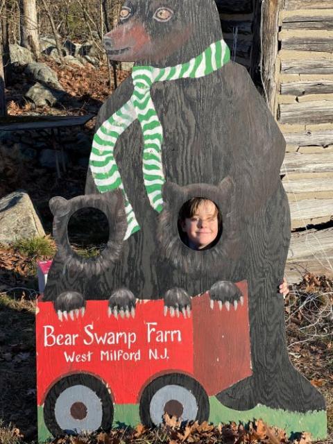 Griffin Hilke poses with a holiday photo prop Dec. 2 at Bear Swamp Farm, where about 9 acres of Christmas trees, along with selective timber harvesting, support about 300 acres of land in its natural state. (Chris Hilke)