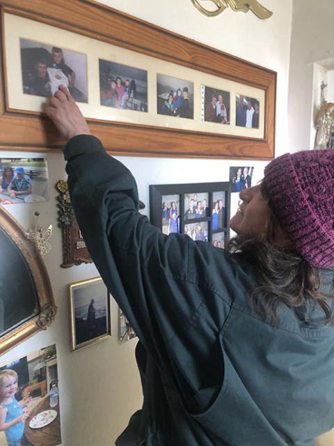 Bonnie McCoy shows an old photo of her three boys in her apartment complex in Southeast Portland. (NCR photo/Katie Collins Scott)