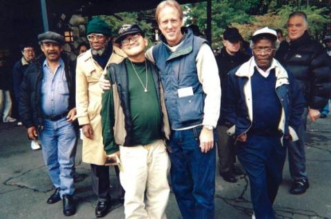 Franciscan Fr. Tom Walters, who helped found St. Francis Friends of the Poor in New York City, is pictured with tenants in the mid-1990s. (Courtesy of St. Francis Friends of the Poor) 