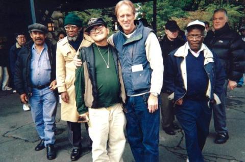 Franciscan Fr. Tom Walters, who helped found St. Francis Friends of the Poor in New York City, is pictured with tenants in the mid-1990s. (Courtesy of St. Francis Friends of the Poor)