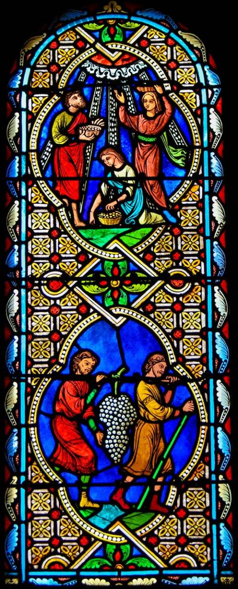 Stained glass window depicting wheat and grape harvests for the Eucharist (Dreamstime/Jorisvo)