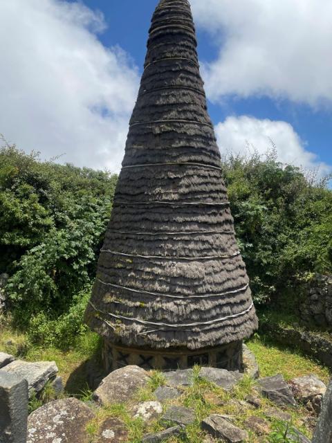 A conical temple dedicated to the deity Moonbu, constructed by members of the Toda tribe in the Nilgiris Hills of southern India with stone, cane and a special type of grass from the sacred grasslands, on Aug. 31, 2023. This temple is located in the heart of a sacred grassland and Toda settlement known as Muttunad Mund. (AP/Deepa Bharath)