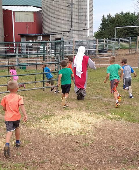 Children spend time with Sr. Maria Lucia Schnaufer, visiting the barns and pens at the Merciful Heart of Jesus Farm outside Marshfield, Wisconsin. (Courtesy of Mary Veronica Fitch)