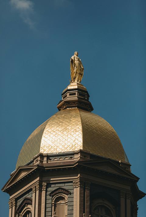 A statue of the Virgin Mary stands atop the Golden Dome at the University of Notre Dame. (Unsplash/Steven Van Elk)