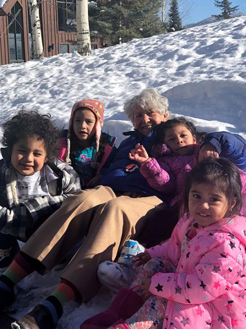 Sr. Mary Ann Pajakowski romps in the snow with students of the School Readiness Program created by Holy Cross Ministries to support Latino families in Park City, Utah. (Courtesy of Miriam Garcia/Holy Cross Ministries)
