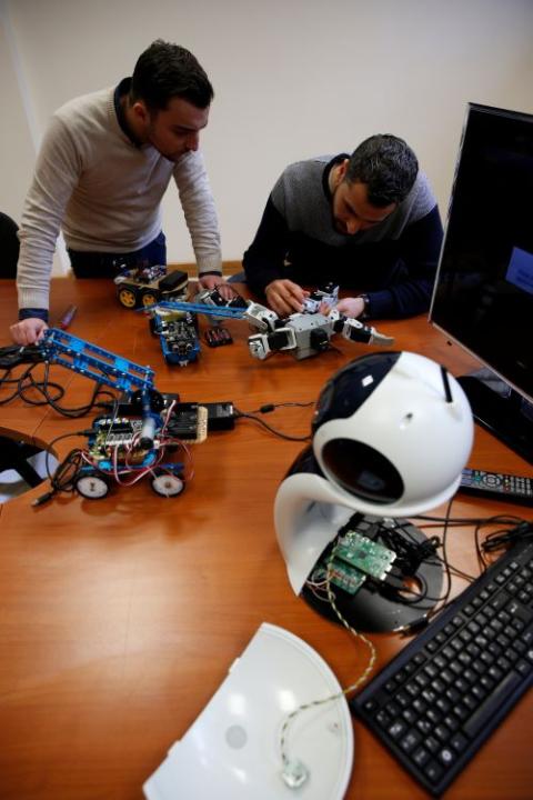 Research support officers and doctoral students Luca Bondin and Foaad Haddad discuss an artificial intelligence project to train robots at the University of Malta in Msida, Malta, Feb. 8, 2019.