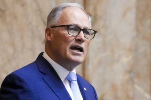 Washington Governor, Jay Inslee. Candid photo of Governor speaking; he wears glasses and blue suit.